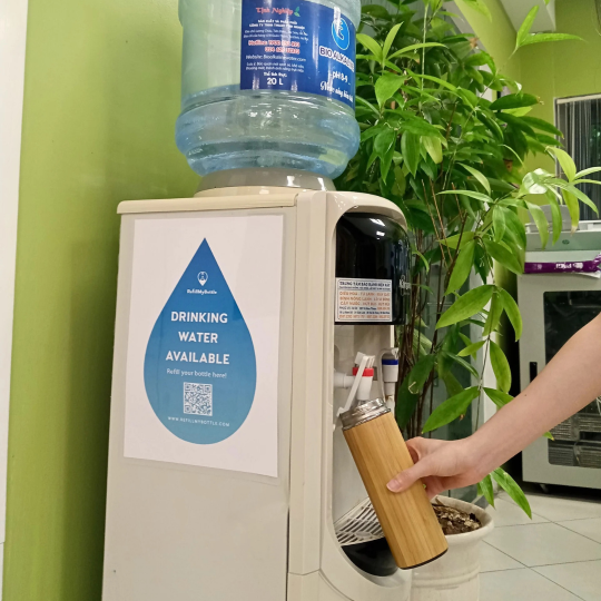 Water dispenser with RefillMyBottle sticker inside an office in Vietnam